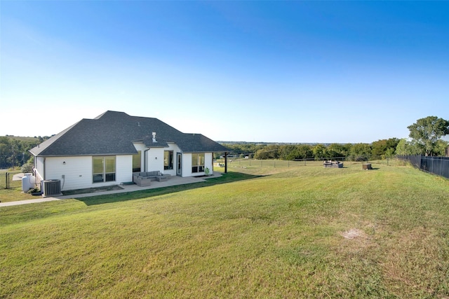 back of house with a patio area, fence, central AC unit, and a lawn