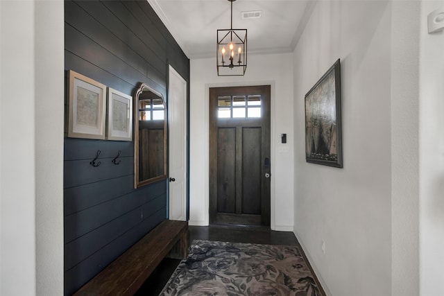 mudroom with ornamental molding, visible vents, baseboards, and an inviting chandelier