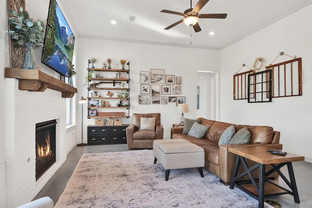 living area with ceiling fan, a fireplace, visible vents, and recessed lighting