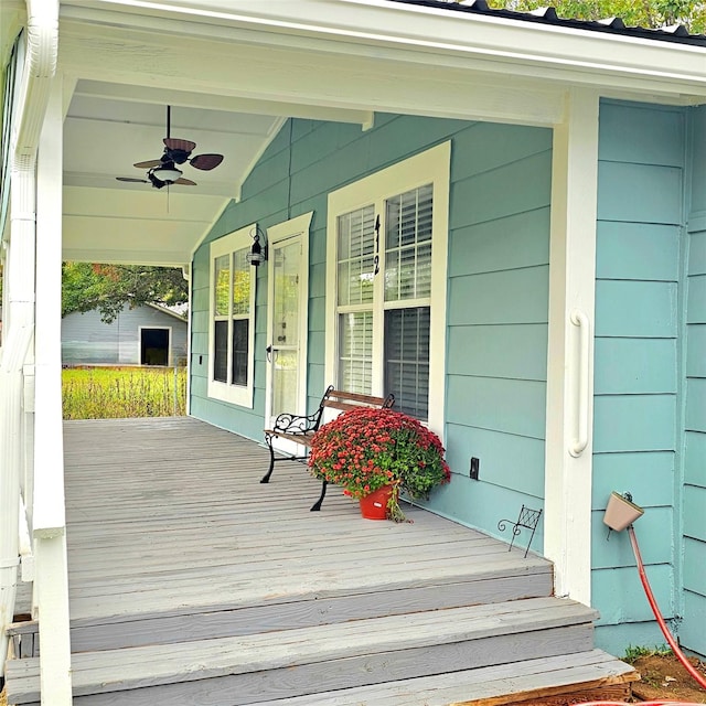 deck featuring covered porch and a ceiling fan