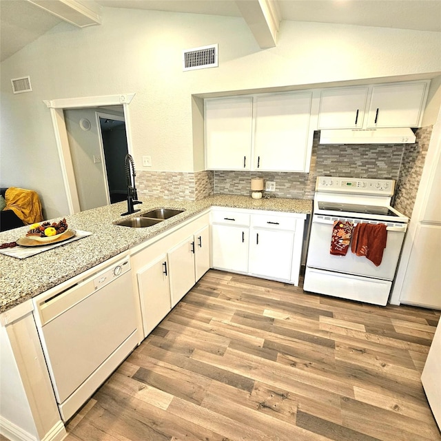 kitchen featuring white appliances, a sink, visible vents, and under cabinet range hood