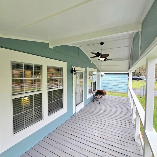 wooden terrace with covered porch and ceiling fan