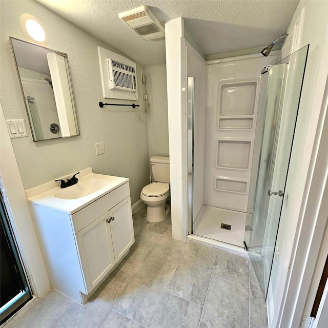 bathroom with toilet, a stall shower, visible vents, and a textured ceiling