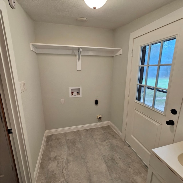 clothes washing area featuring hookup for a washing machine, cabinet space, electric dryer hookup, and baseboards