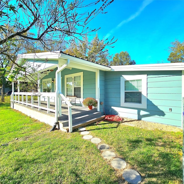 exterior space with covered porch and a front lawn