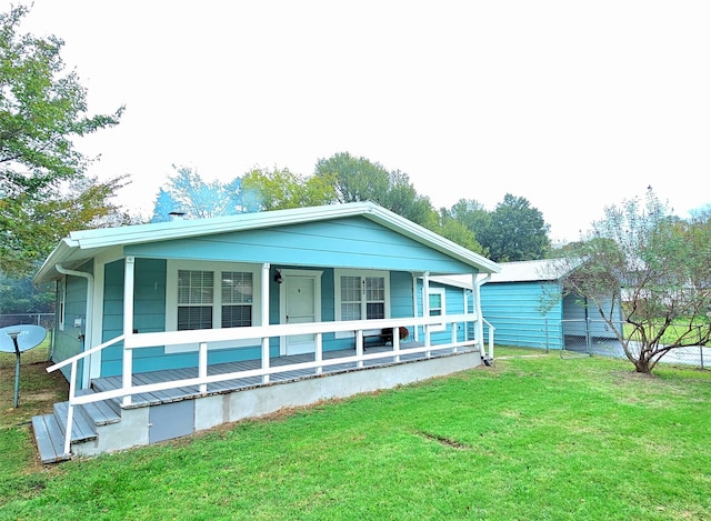 view of front of house featuring a front yard and covered porch