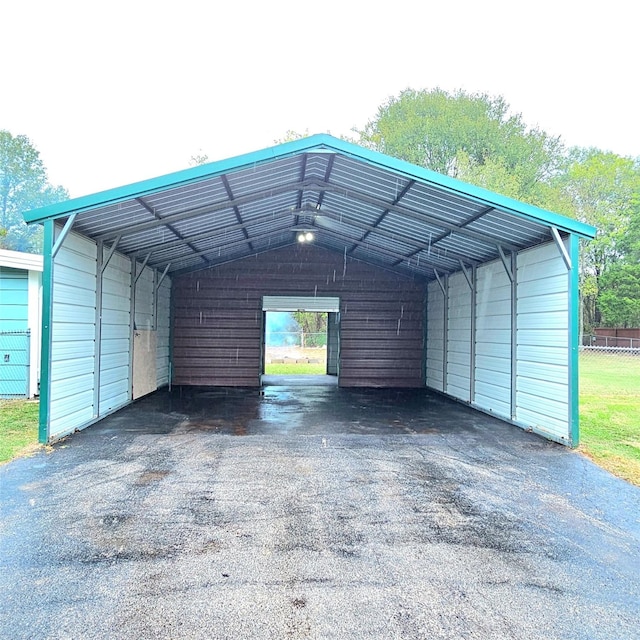 view of parking featuring driveway and a detached carport