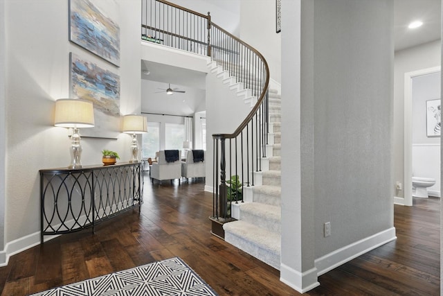 2813 Carrington Dr, Mansfield, TX 76063 - stairway with a towering ceiling, a ceiling fan, hardwood / wood-style floors, and baseboards