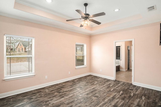 136 Clara Lee Ln, Springtown, TX 76082 - empty room with a tray ceiling, dark wood-style flooring, plenty of natural light, ornamental molding, and baseboards