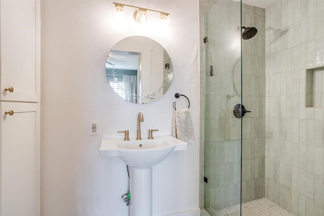 full bathroom with a sink and a tile shower