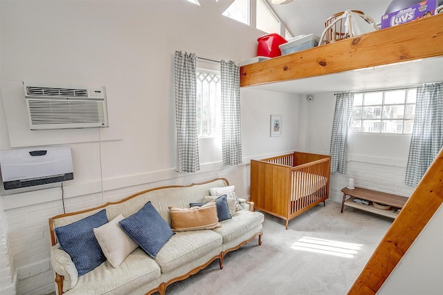 carpeted bedroom featuring a high ceiling and a wall mounted air conditioner