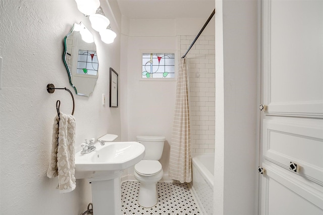 bathroom featuring tile patterned flooring, toilet, and shower / bathtub combination with curtain