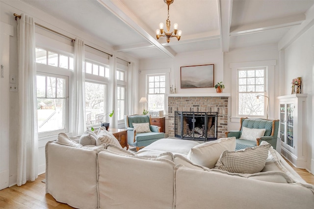 living area with a brick fireplace, coffered ceiling, light wood-style flooring, and beam ceiling