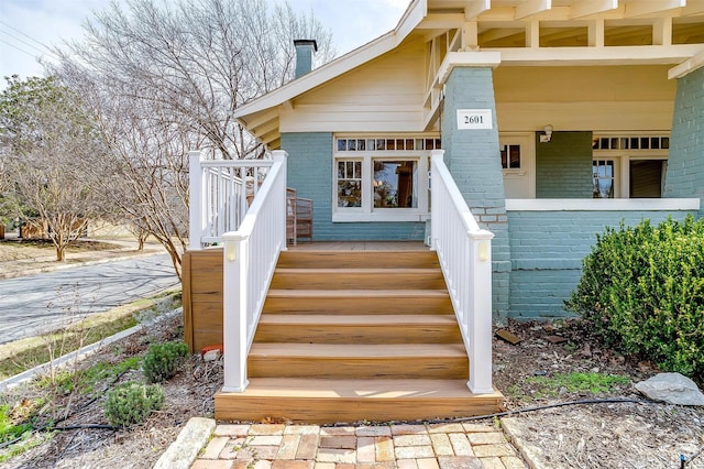 property entrance featuring brick siding