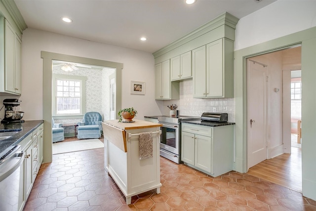 kitchen featuring recessed lighting, decorative backsplash, appliances with stainless steel finishes, a ceiling fan, and wood counters