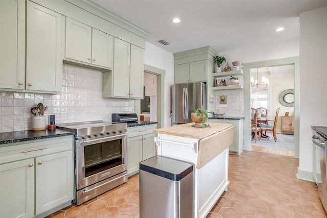 kitchen featuring stainless steel appliances, open shelves, wood counters, and decorative backsplash