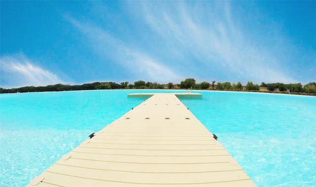 view of swimming pool with a water view and a boat dock