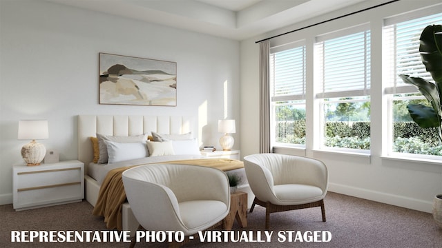 carpeted bedroom with multiple windows and baseboards