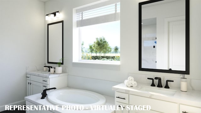 full bath featuring two vanities, a sink, and a bath