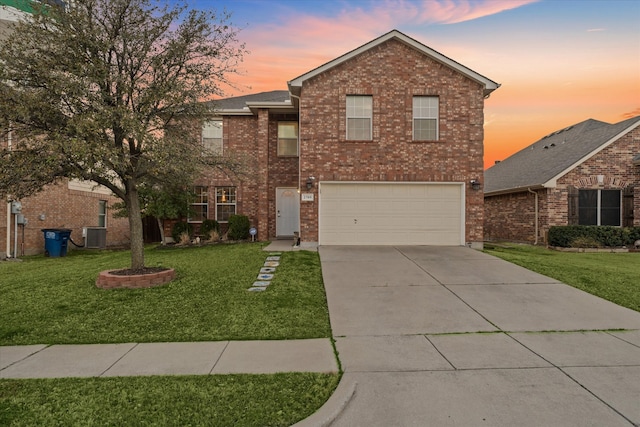 traditional home featuring driveway, a front lawn, a garage, central air condition unit, and brick siding