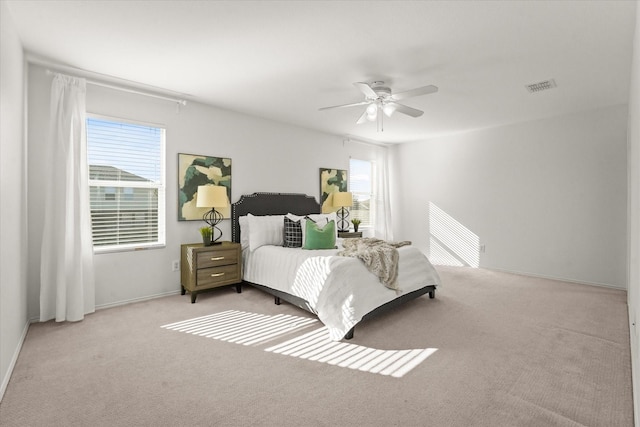 bedroom featuring visible vents, baseboards, a ceiling fan, and carpet flooring