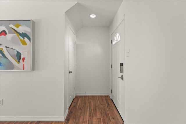 hallway with baseboards and dark wood-style flooring