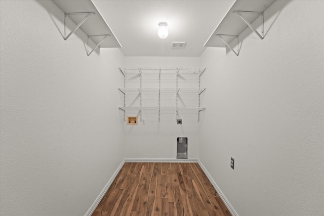 laundry room featuring washer hookup, laundry area, wood finished floors, and baseboards