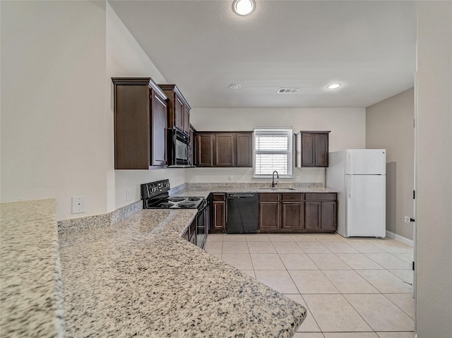 kitchen featuring light tile patterned floors, visible vents, a sink, dark brown cabinets, and black appliances