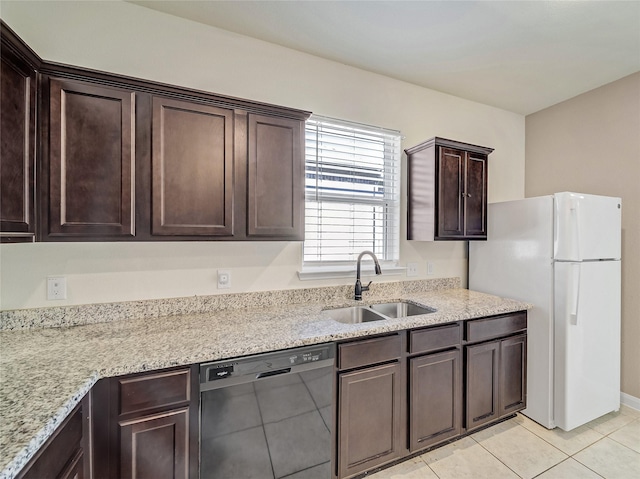 kitchen featuring a sink, dark brown cabinetry, dishwasher, and freestanding refrigerator