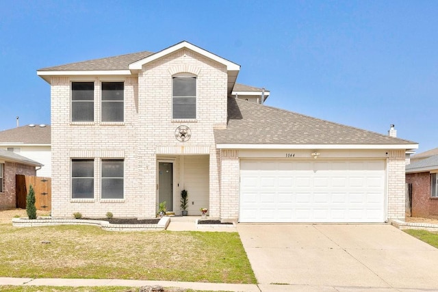 traditional-style home featuring an attached garage, brick siding, a shingled roof, driveway, and a front lawn