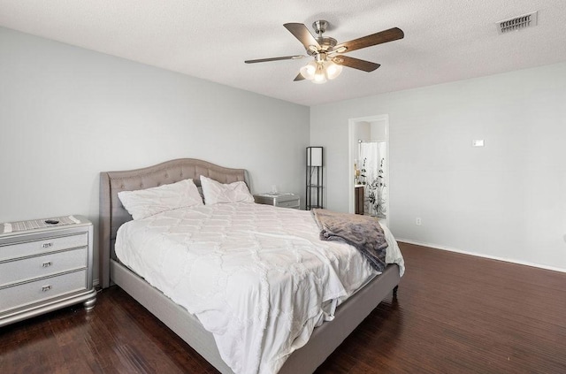 bedroom with baseboards, visible vents, a ceiling fan, wood finished floors, and a textured ceiling