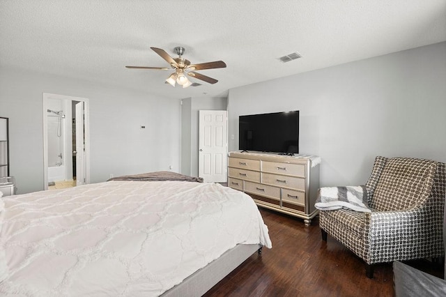 bedroom with a textured ceiling, ceiling fan, dark wood-type flooring, and visible vents