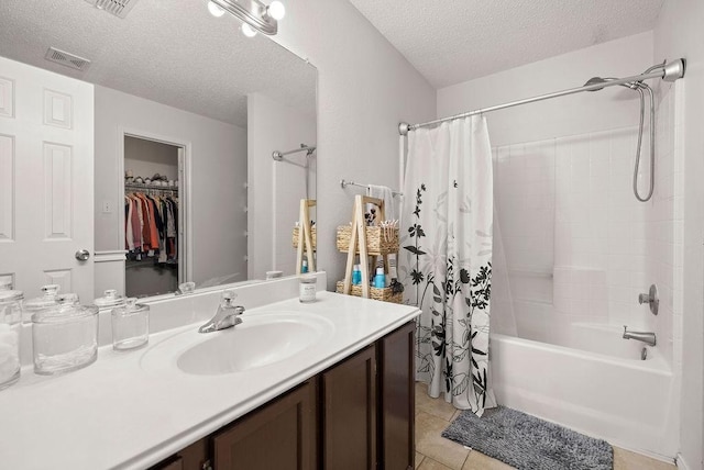 full bath featuring a textured ceiling, shower / tub combo, visible vents, and tile patterned floors