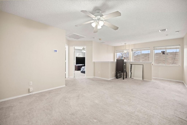 unfurnished living room featuring baseboards, visible vents, and light colored carpet