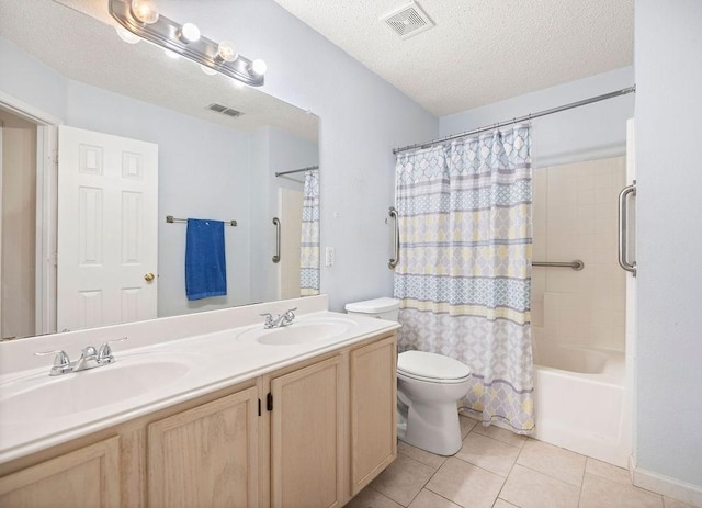 bathroom featuring visible vents, a sink, and tile patterned floors