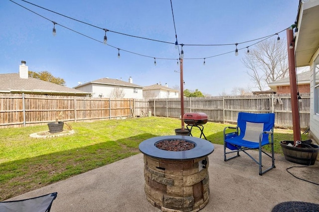 view of patio featuring an outdoor fire pit and a fenced backyard