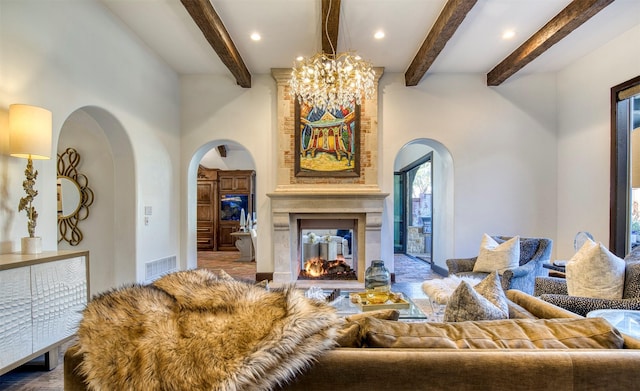 living room with arched walkways, beamed ceiling, a multi sided fireplace, and visible vents