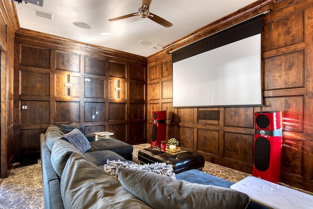 cinema featuring carpet floors, wooden walls, visible vents, and a ceiling fan