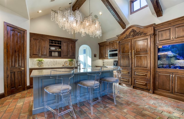 kitchen featuring arched walkways, oven, decorative backsplash, and open shelves