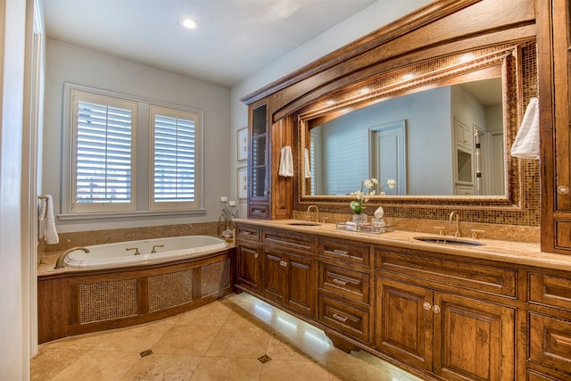 full bathroom with tile patterned flooring, a garden tub, a sink, and double vanity