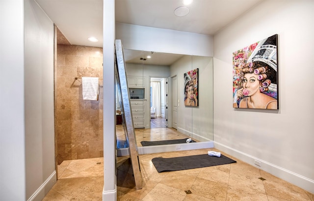 hall featuring recessed lighting and baseboards