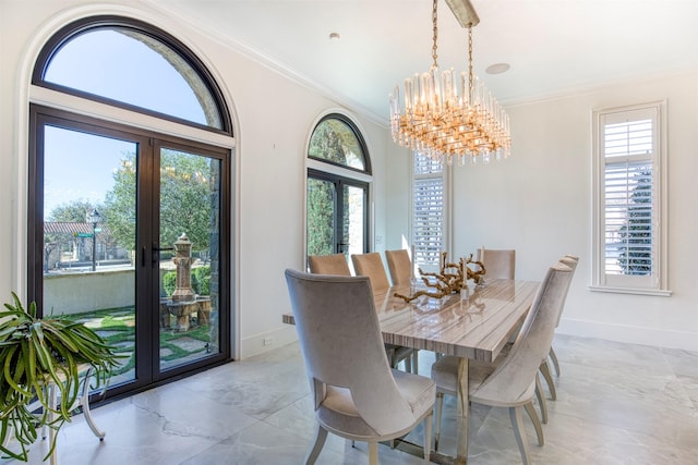 dining area featuring a wealth of natural light, baseboards, crown molding, and french doors