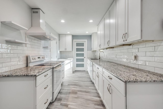 kitchen featuring a sink, extractor fan, light stone counters, white appliances, and open shelves