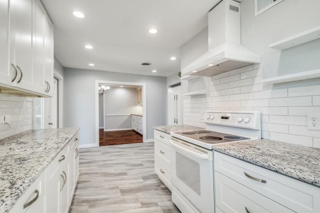 kitchen featuring range hood, white appliances, white cabinetry, and open shelves