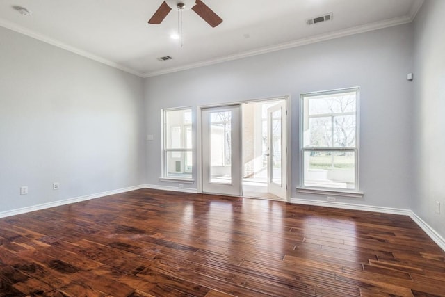 unfurnished room featuring dark wood-type flooring, crown molding, visible vents, and baseboards