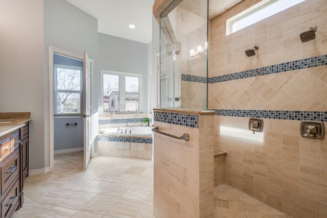 bathroom with baseboards, walk in shower, a garden tub, tile patterned floors, and vanity