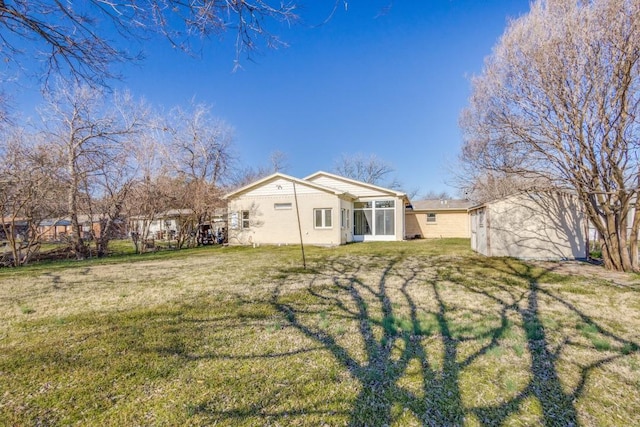 back of house with a lawn