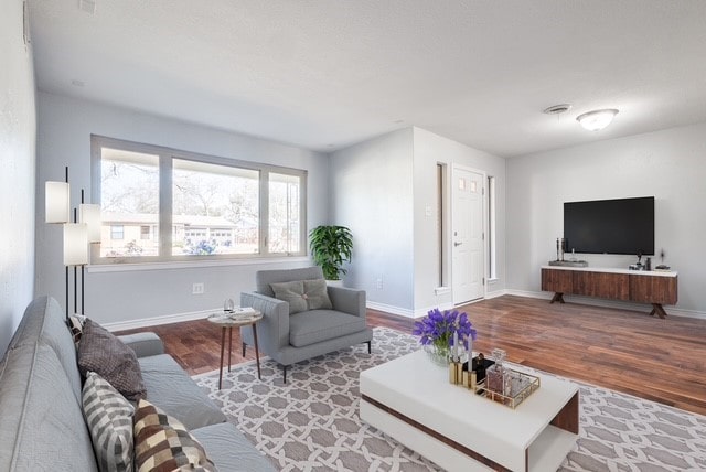 living room featuring baseboards and wood finished floors