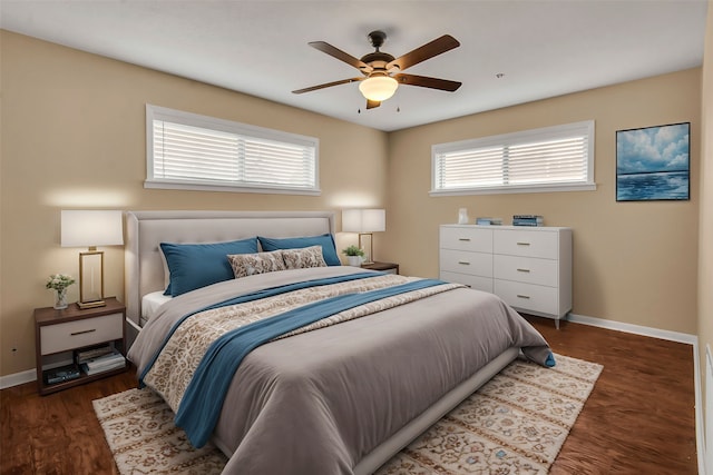 bedroom featuring multiple windows, wood finished floors, and baseboards