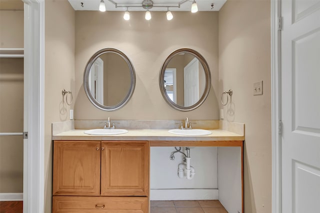 bathroom with double vanity, a sink, and tile patterned floors